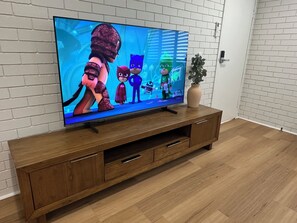 Family Apartment | Living area | 65-inch Smart TV with digital channels, Netflix, streaming services - Central Cullen Apartments  (Wagga Wagga)