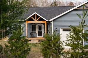 A house with a porch, a door, and a garage.