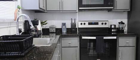 Fridge, microwave, stovetop, coffee/tea maker