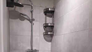 A shower with a handheld showerhead and a wall-mounted faucet. - Klimt2 – spacious 2-bedroom apt in Bielsko center, ideal for families & groups (Bielsko-Biała)