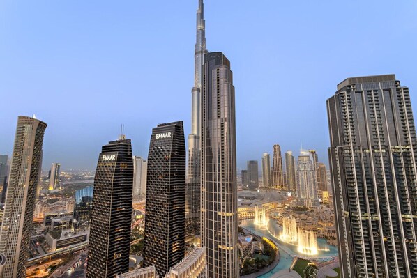 A cityscape with high-rise buildings, including a prominent tower with 'EMAAR' signage.