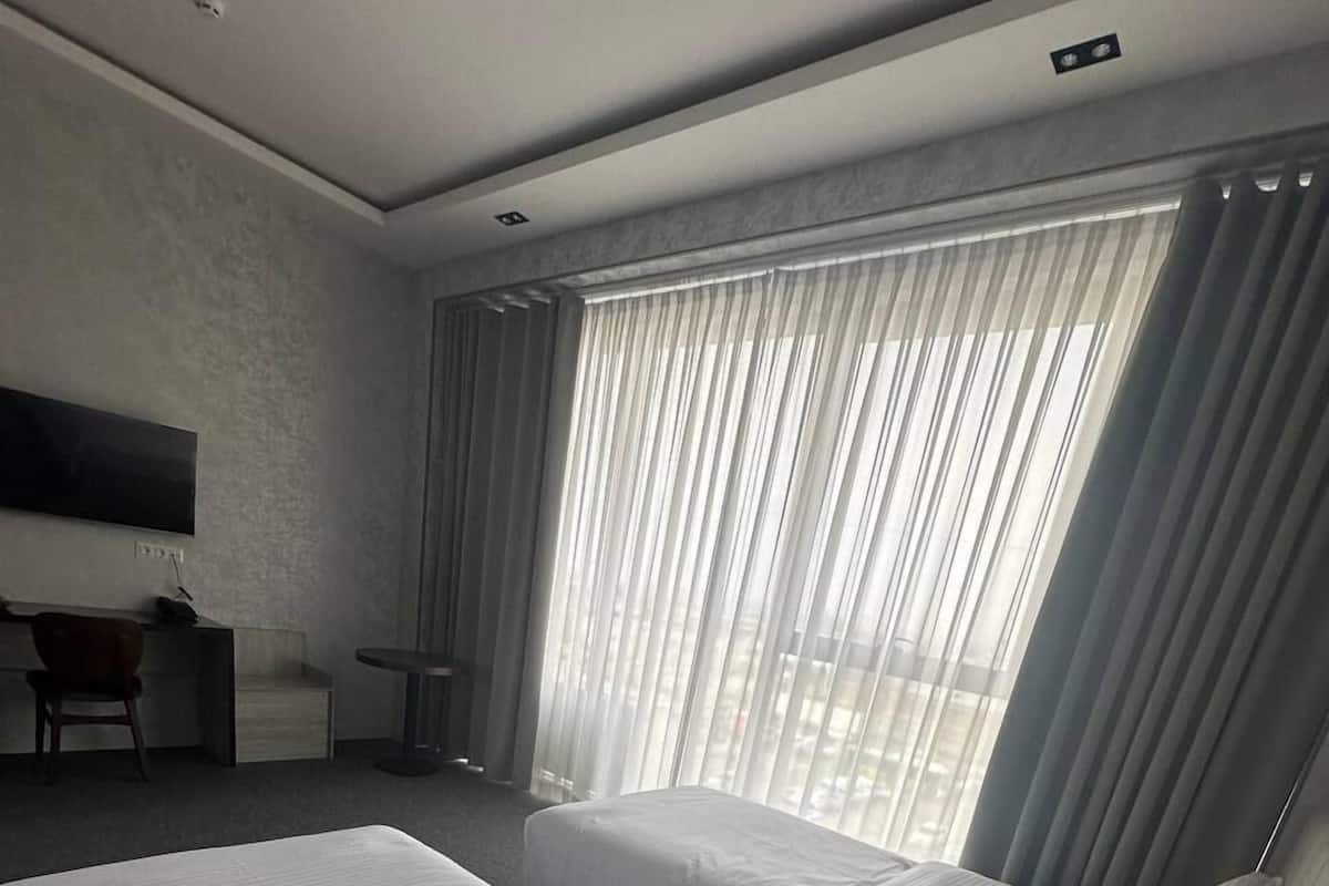 Standard Twin Room, City View | In-room safe, desk, laptop workspace, blackout drapes