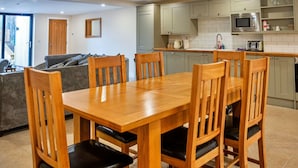 A modern kitchen with grey cabinets, a microwave, and a toaster. - Wonderful  villa for 6 guests with hot tub, WIFI and pets allowed (Cirencester)
