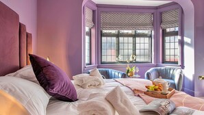 A room with a bed, two chairs, a window with patterned shutters, and a tray with food and drinks. - Stunning  villa for 12 guests with WIFI, hot tub and terrace (Nottingham)