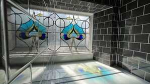 A bathroom with black tiled walls, a glass shower enclosure, and a stained glass window. - The Royal Tay Apartment - Stained Glass and River Views (Dundee)