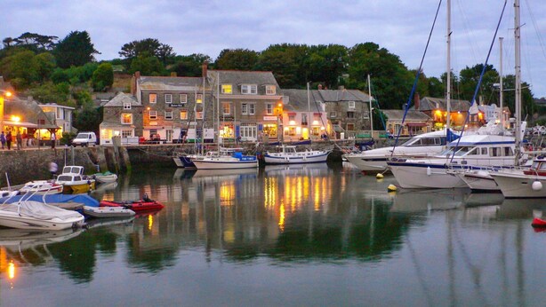 A marina with boats docked, buildings with lights, and a calm water surface reflecting the surroundings. - Beautiful  villa for 19 people with hot tub, WIFI, TV, terrace and pets allowed (Newquay)