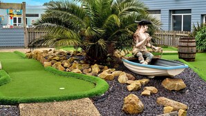 A landscaped garden with a statue of a pirate in a boat, palm trees, and a small pond. - Beautiful  villa for 6 people with pool, WIFI, terrace and pets allowed (Ruan Major)