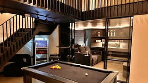 A billiards table with balls, a sofa, and a staircase in a modern interior. - Stunning  villa for 6 people with WIFI and pets allowed (Stone)
