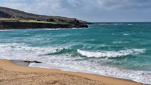 A beach with waves crashing onto the shore, a rocky coastline, and a clear sky. - Beautiful apartment for 4 guests with WIFI (St Ives)