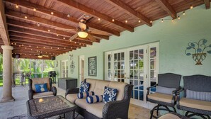 A covered patio area with wicker furniture, ceiling fans, and string lights. - 16 Mi to Fort Lauderdale: Florida Escape w/ Pool! (Plantation)
