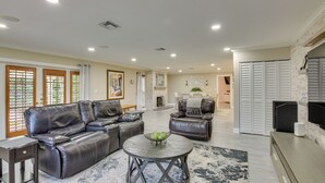 A spacious living room with a leather sectional sofa, a round coffee table, and a fireplace. - 16 Mi to Fort Lauderdale: Florida Escape w/ Pool! (Plantation)
