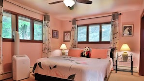 A bedroom with a bed, two bedside lamps, a heater, a window with curtains, and a ceiling fan. - Private 5-acre Lake: Pet-friendly Grove City Home (Grove City)