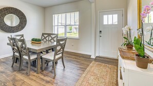 A dining area with a wooden table and chairs, a large mirror, and a view of the outdoors through a window. - Pool Access, 2 Mi to Main St: Fountain Inn Home! (Fountain Inn)