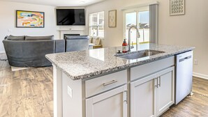 A modern kitchen with granite countertops, a built-in dishwasher, and a large window. - Pool Access, 2 Mi to Main St: Fountain Inn Home! (Fountain Inn)