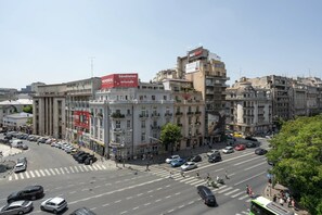A city street with buildings, cars, and pedestrians.