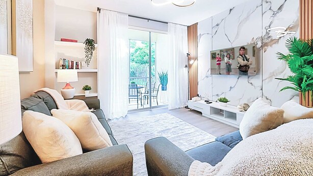A modern living room with a sofa, a TV mounted on the wall, a bookshelf, and a view of the outdoors. - 8908 Family Fun in Kissimmee Spacious 4-bedroom Apartment Near Theme Parks (Kissimmee)