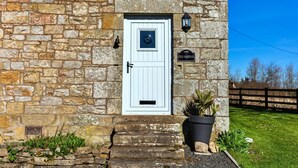 A stone building with a white door, a sign reading "Old School," and a potted plant at the entrance. - Beautiful  villa for 4 guests with WIFI and terrace (Edlingham)