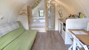 A compact, well-lit interior with a bed, kitchenette, and shower area. - Beautiful  villa for 4 people with WIFI and terrace (Hexham)