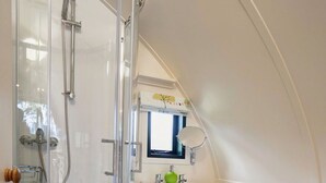 A bathroom with a glass-enclosed shower, a pedestal sink, a toilet, and a window with a view of trees. - Beautiful  villa for 4 people with WIFI and terrace (Hexham)