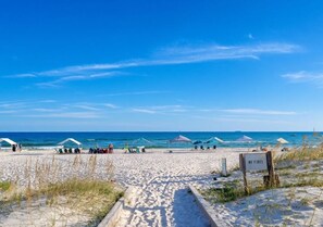 A beach with tents and a 'NO FIRES' sign. - Spacious Family-Friendly | Pet-Friendly Beach House | Pool | Sleeps 10 (Gulf Shores)