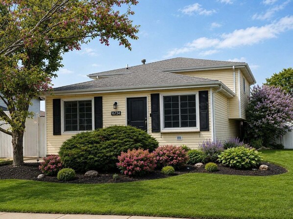 A single-story house with a number '16734' on the front, surrounded by well-maintained landscaping and a clear sky. - Modern Retreat With Private Pool & Yard 3 Bedroom Home (Tinley Park)
