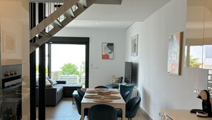 A modern kitchen with a dining area, a staircase, and a view of the outdoors. - Holiday Home 'Great Townhouse Close To The Beach' with Sea View, Wi-Fi and Air Conditioning (Manilva)