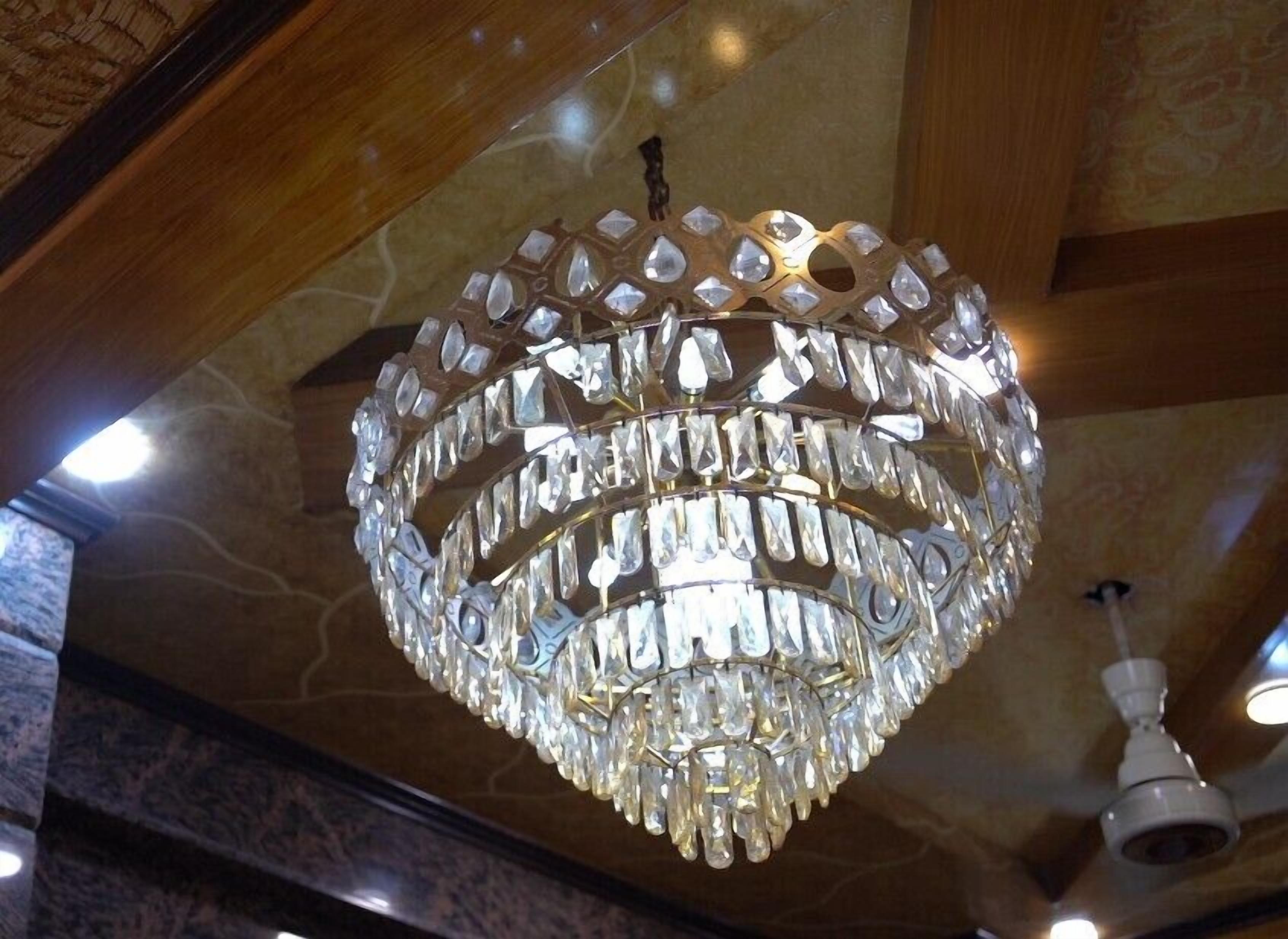 A chandelier with multiple tiers of clear crystals.