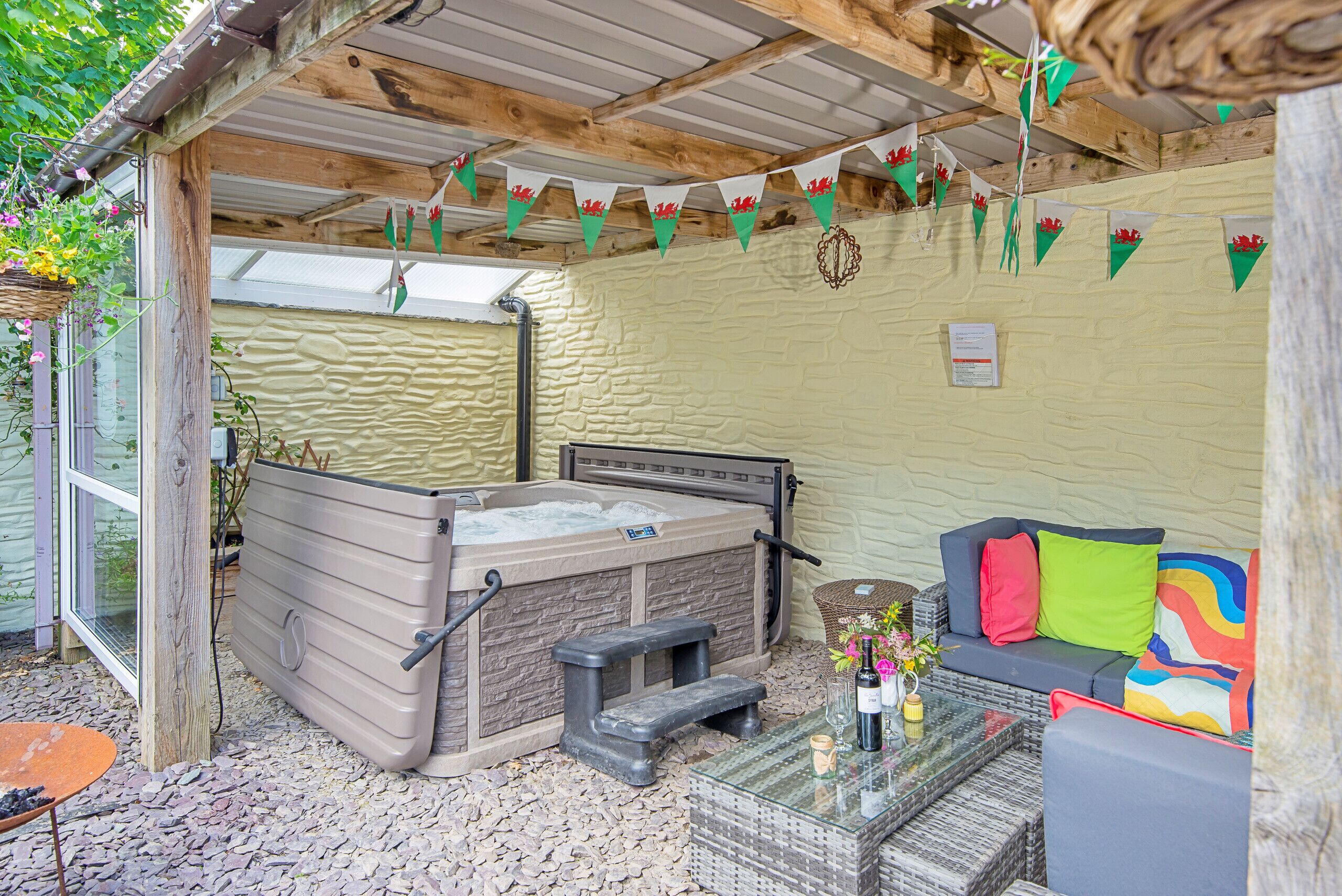 A spa area with a hot tub, seating, and decorative elements.