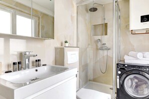 Shower, hair dryer, towels, shampoo