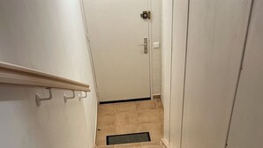 A narrow stairway with beige tiles leading to a white door. - Appartement Le Lavandou centre (Le Lavandou)