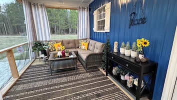 Beautiful screened 300 sq ft porch offers seating, fans, 2-person hot tub.