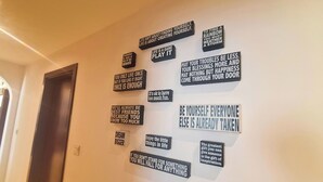 A hallway with motivational signs on the wall. - Tratoli Hostel in JBR with Sea Views (Dubai)