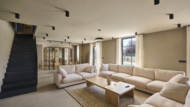 A spacious living room with a large sofa, a coffee table, and a staircase leading to another level. - Villa Madora in Porec (Porec)