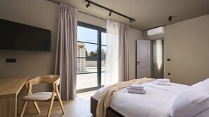 A modern hotel room with a bed, a desk, a chair, and a large window. - Villa Madora in Porec (Porec)