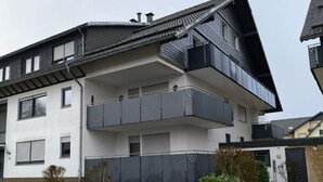 A modern two-story residential building with a flat roof, large windows, and a balcony on the upper floor. - Apartment in Winterberg Near Ski Lift (Winterberg)