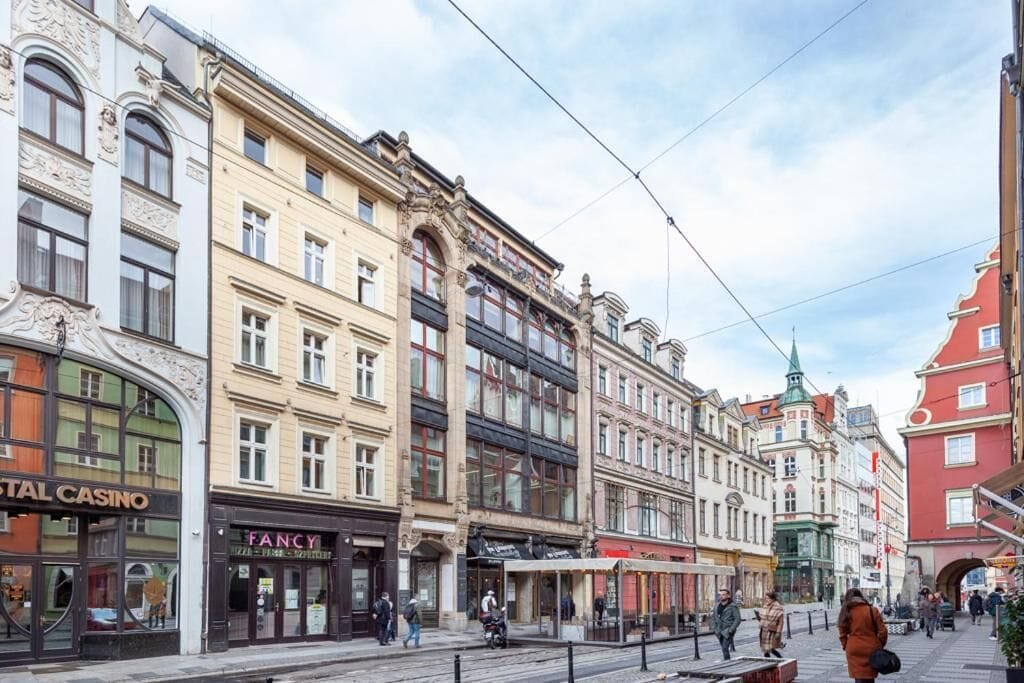 A street with historic buildings, including a casino and a fancy store.