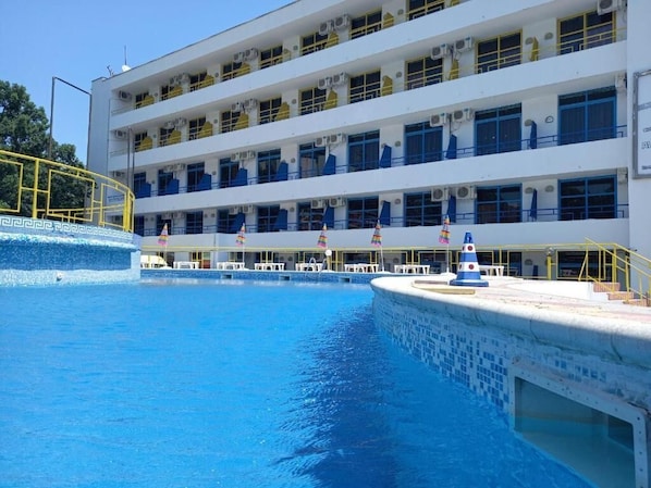 Seasonal outdoor pool, pool umbrellas, pool loungers