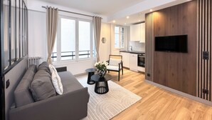 A modern apartment with a living room, kitchen, and dining area. - 1628 Matignon (Paris)