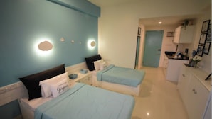 A hotel room with two beds, a kitchenette, and a bathroom. - FF21-KDH (Bengaluru)