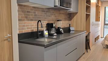 Fridge, microwave, coffee/tea maker, cookware/dishes/utensils