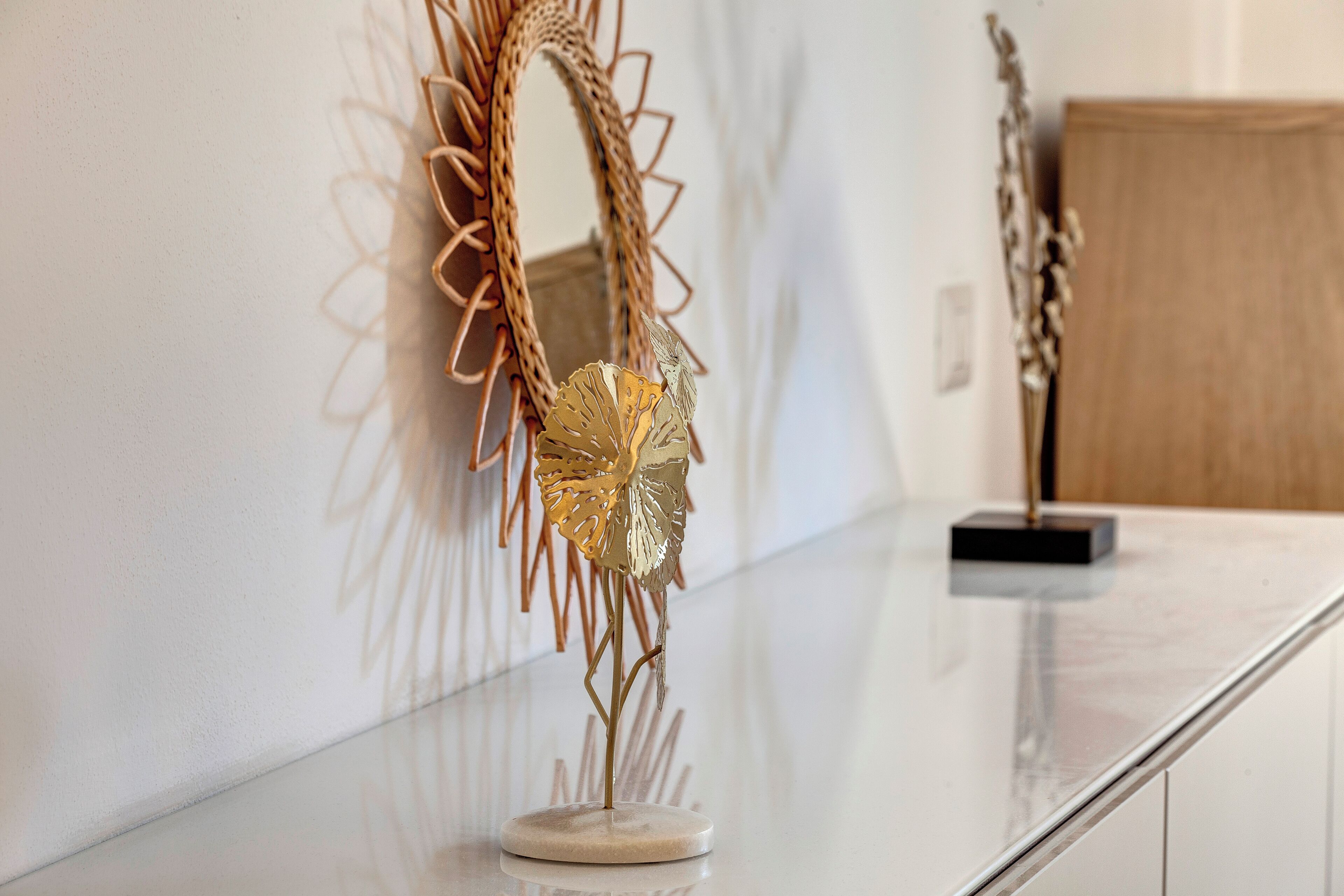 A polished marble counter with a decorative metal sculpture.