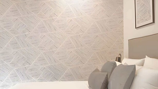 A bedroom with a geometric patterned wallpaper, a bed with white bedding and gray pillows, and a framed picture on the wall. - Two connected units on Paseo Chapultepec (Guadalajara)
