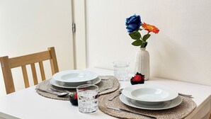 A dining table set with plates, cutlery, and a glass of water. - Rooftop Blu Infinito by Ca-Sa Check (Chioggia)