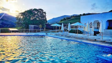 Seasonal outdoor pool, open 8:00 AM to 6:00 PM, pool umbrellas