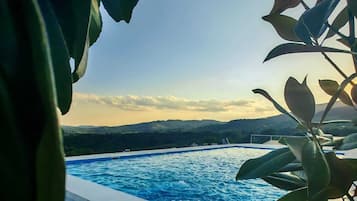 Seasonal outdoor pool, open 8:00 AM to 6:00 PM, pool umbrellas