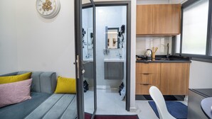 A modern kitchen with wooden cabinets, a sink, and a window. - Business & Chill Studio 3 minutes from the Grand Stade (Tanger)