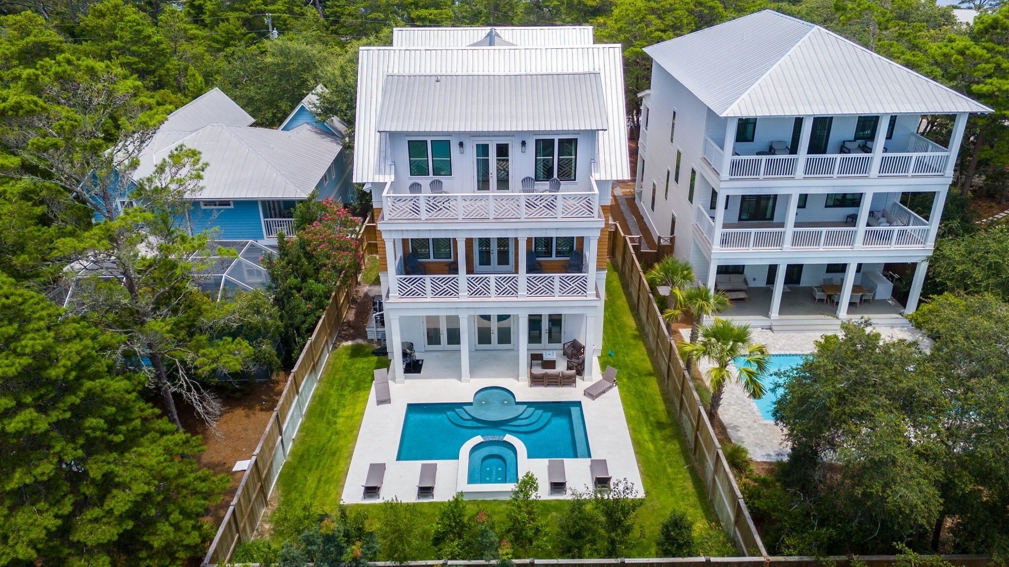 A large, two-story house with a swimming pool in the backyard.
