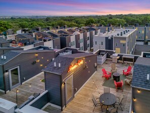 A rooftop terrace with outdoor seating and string lights. - Rooftop Deck Grill Ping Pong Near Downtown Nashville (Nashville)