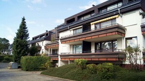 A modern multi-story residential building with balconies, large windows, and a paved driveway. - Apartment in Winterberg Near Ski Lift (Winterberg)