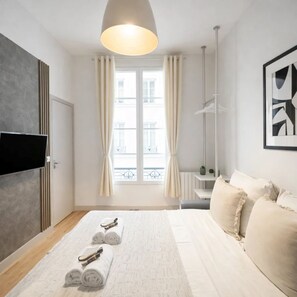 Classic Apartment, Courtyard View | Living area | 80-cm Smart TV with digital channels
